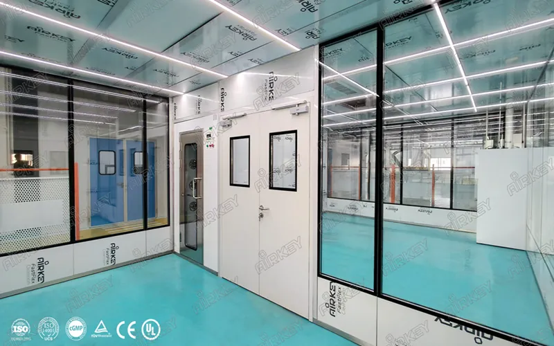 Cleanroom entrance with air shower system and access door for laser machinery production environment